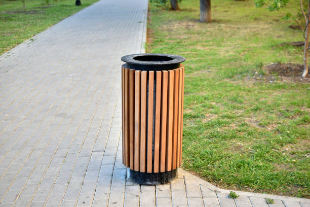 istock City park with garbage cans and flower beds 1334506355