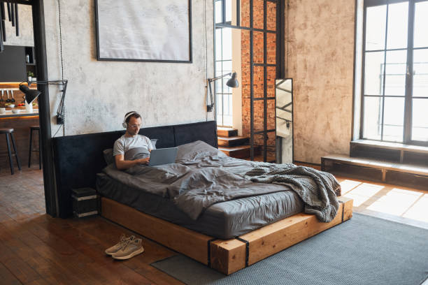 istock Man Relaxing in Bed Wide Angle 1334507468