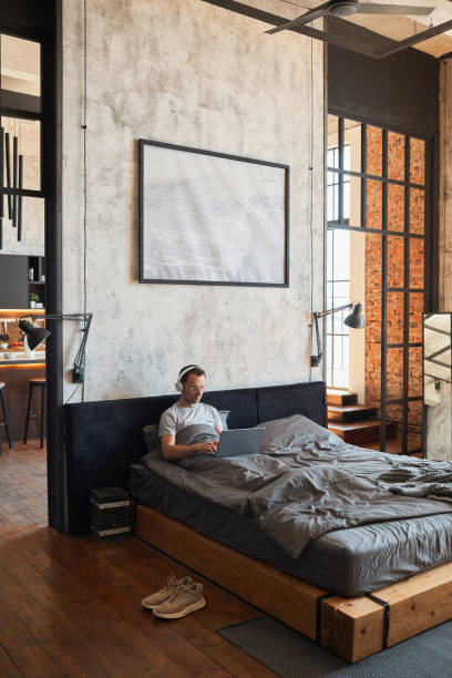 istock Wide Angle Man Relaxing in Bed 1334507472