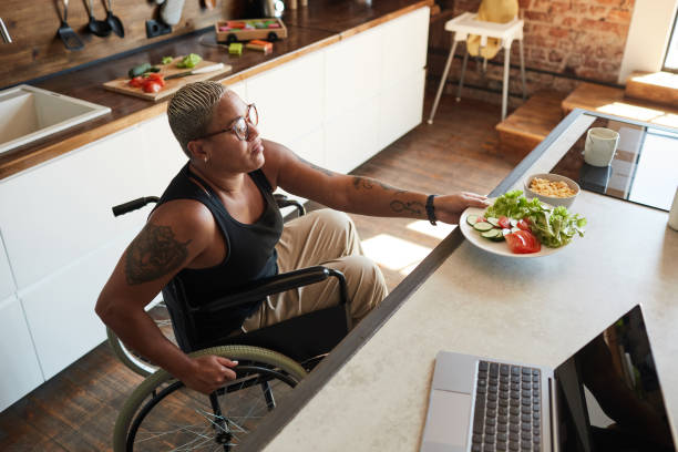 istock Woman with Disability Making Breakfast 1334507508