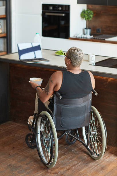 istock Woman with Disability Watching Videos Online 1334507520