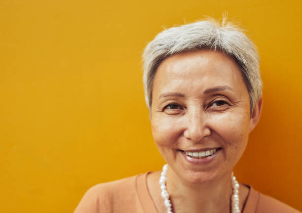 istock Smniling Mature Woman on Yellow 1334507701