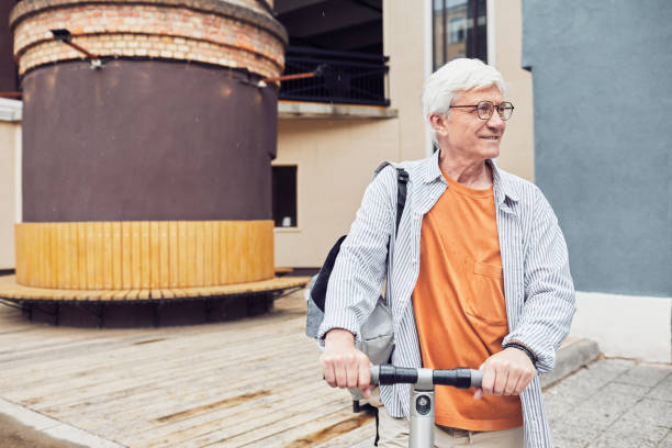 istock Mature Man Riding Scooter in City 1334507732