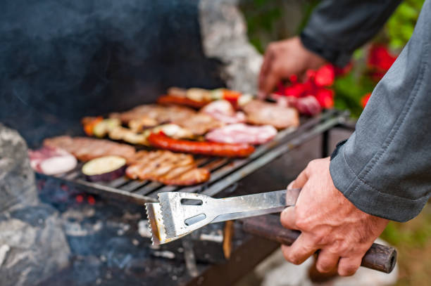 istock Man cooking meat on barbecue grill at bbq party 1334507737