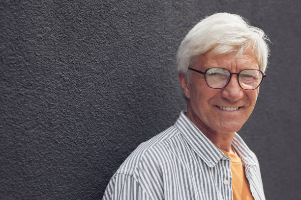 istock Portrait of Smiling Mature Man on Grey 1334507777
