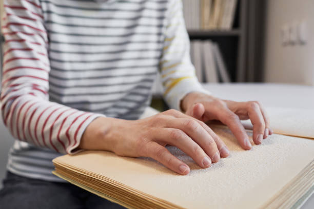 istock Woman Reading Braille Book 1334509919