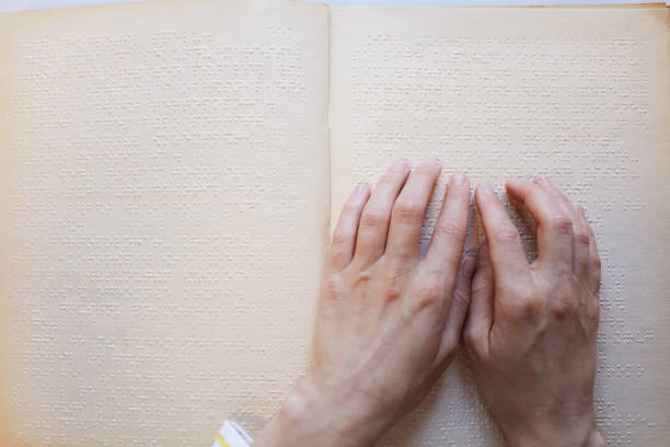 hands reading braille - tillgänglighet blind braille bildbanksfoton och bilder
