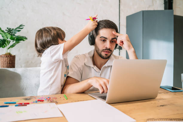 istock Man working from home while taking care of his son. 1334511175