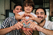 Happy gay couple with their son.