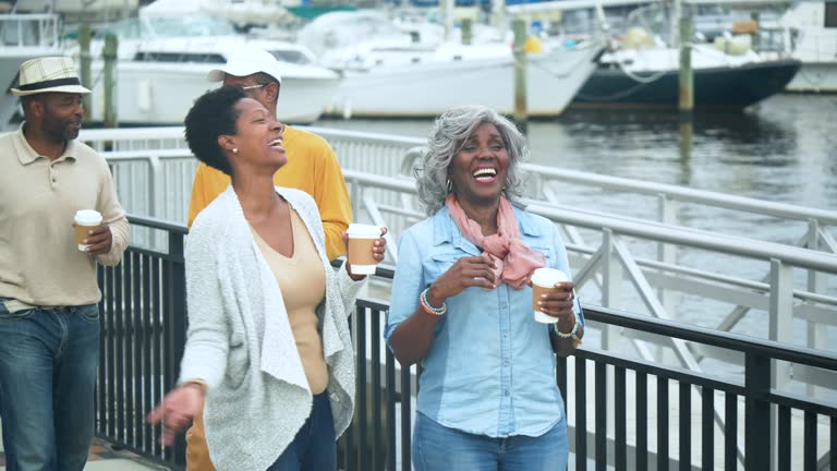 African-American family walking by marina, conversing