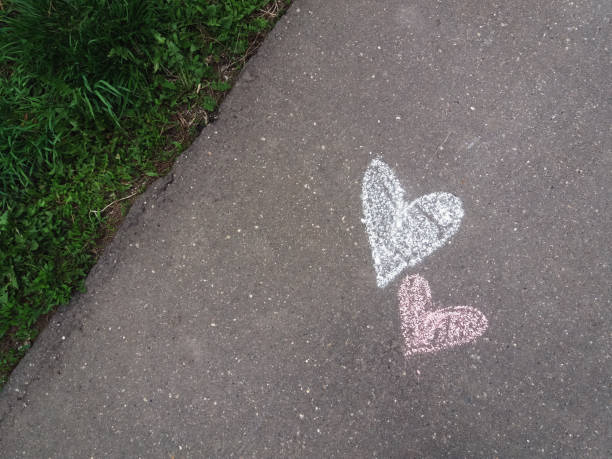 istock Hearts drawn with chalk on the asphalt sidewalk 1334513684