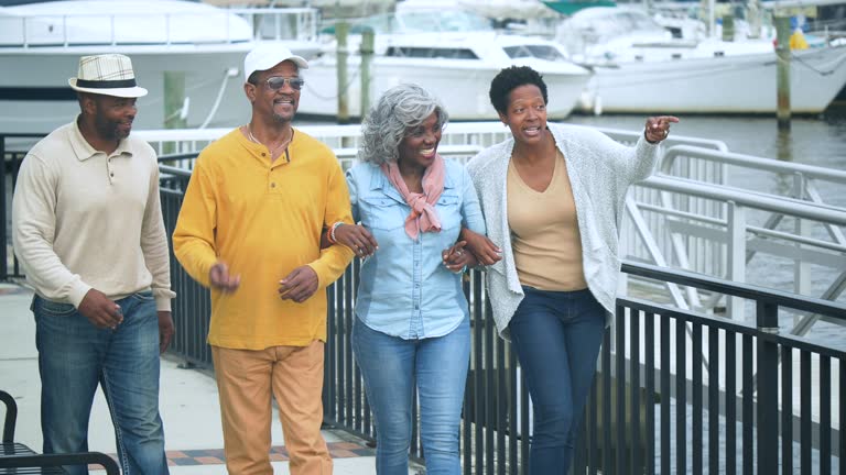 African-American family walking by marina, conversing