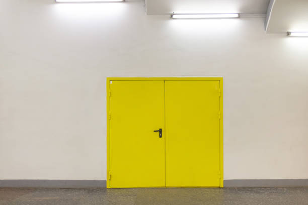 istock Closed yellow door on white wall 1334517680