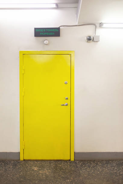 istock Closed yellow door on white wall 1334517696