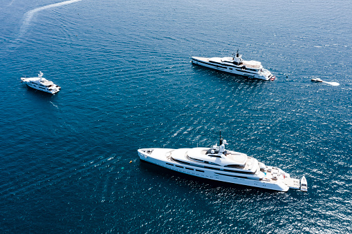 View from above, stunning aerial view of some luxury yachts sailing on a blue water. Sardinia, Sardinia, Italy.