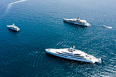 View from above, stunning aerial view of some luxury yachts sailing on a blue water. Sardinia, Sardinia, Italy.