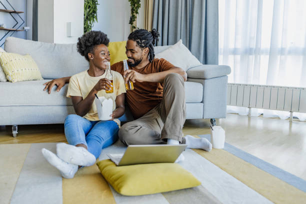 istock Ordering and eating fast food meal at home and watching online content 1334522331