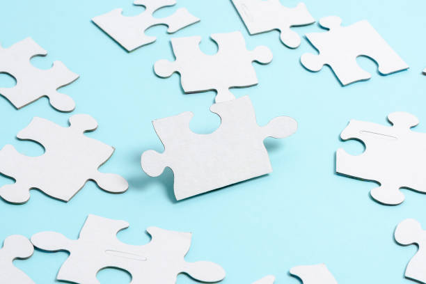 istock Close-Up White Jigsaw Pattern Puzzle Pieces To Be Connected With Missing Last Piece Positioned On A Flat Lay Background With Different Texture And Paper Supplies Accesories 1334522394