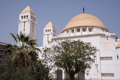 Dakar, Senegal - May 30, 2014: Towers and dome of the Christian Cathedral of Our Lady of Victories in the urban center of the city