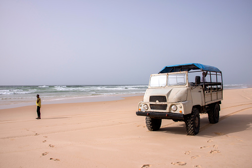 Dakar, Senegal - May 28, 2014: 4x4 truck driving along the beaches on the coast near Lake Rosa