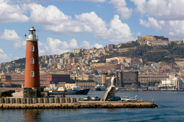 Entering and exiting the harbor in Naples, Italy you will see the famous Molo San Vincenzo Lighthouse and a holy statue to greet you.