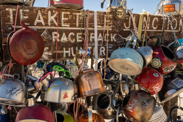 Teakettle Junction Sign Covered In Teapots Death Valley National Park, United States: February 18, 2021: Teakettle Junction Sign Covered In Teapots along a remote intersection in Death Valley teakettle junction stock pictures, royalty-free photos & images
