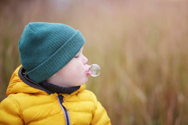 istock portrait of a little boy blowing bubbles 1334526576