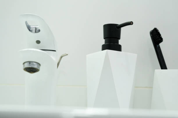 istock Collection of assorted bathroom tools, liqud soap, toothbrushes, on white background. Set of zero waste cleaning products. Modern bathroom 1334530846