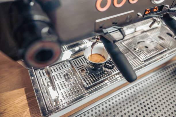 istock Professional coffee machine brewing espresso in coffee shop 1334531041