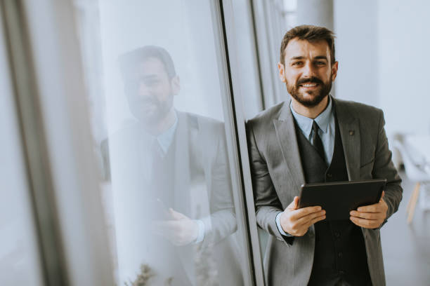 istock Young modern businessman using digital tablet in the office 1334531068