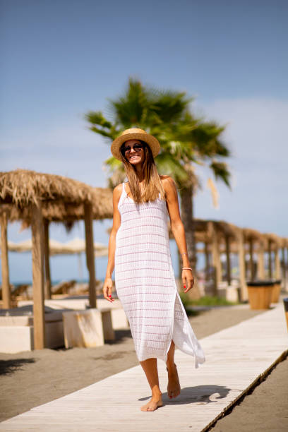 istock Young woman walking on a beach at summer 1334531079