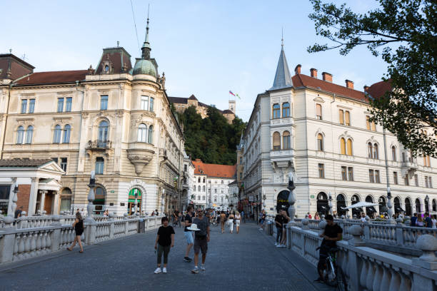 View from Triple bridge over Stritarjeva street till the castle in Ljubljana Slovenia Ljubljana, Slovenia - August 13, 2021: Stritarjeva street leads from the triple bridge to the Robbov fountain and than to the city hall and forward to the castle of Ljubljana. It is one of the most walked and crowded streets in the Slovene capital. ljubljana castle stock pictures, royalty-free photos & images