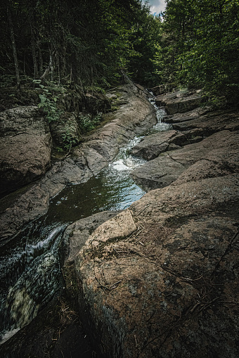 In the rocks, a small waterfall.