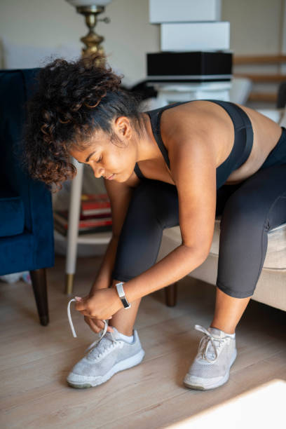 istock woman tying athletic shoes 1334534104