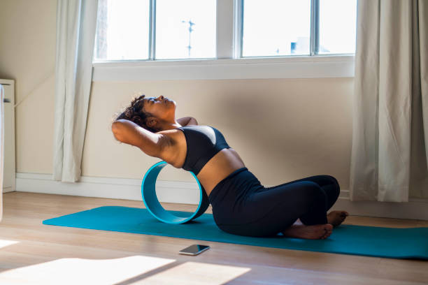 istock woman stretching on exercise wheel 1334534120
