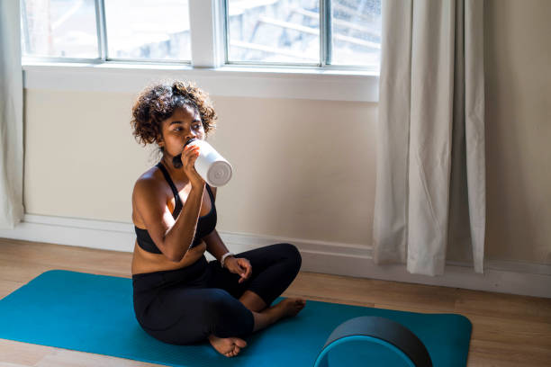 istock woman drinking from water bottle 1334534122