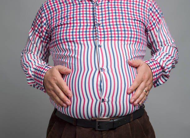 istock Mid section of an overweight man, studio shot 1334535139