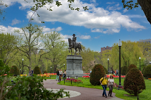 May 10, 2014 - Boston, Ma, USA - Visitors still through the historic Boston Commons near the historic George Washington statue