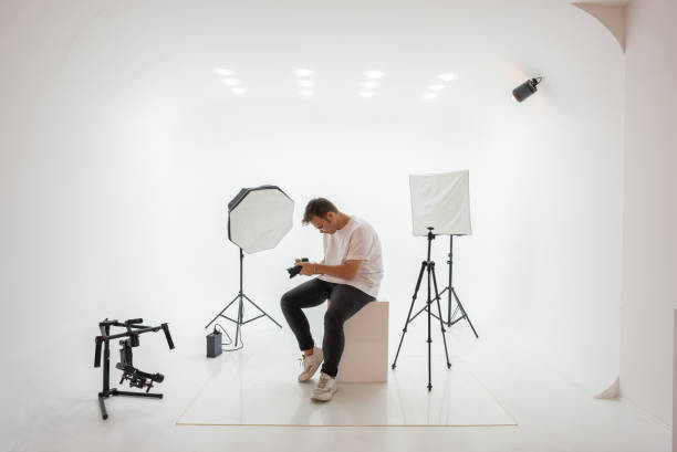 istock Young photographer choosing photo in studio. 1334539734