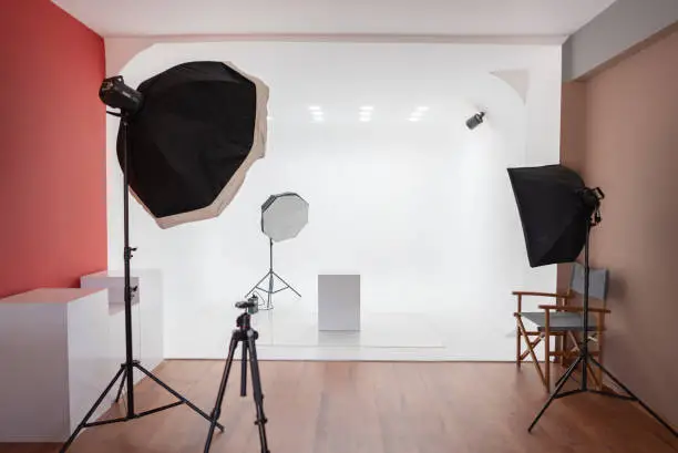 Professional photo studio with flash lights, stands, camera and background equipments