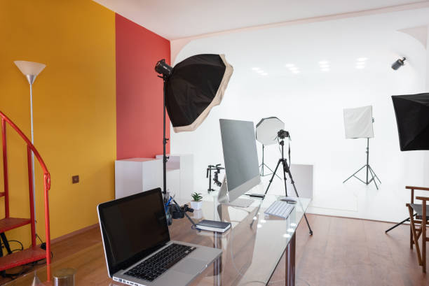 istock Modern Empty photo studio with photography lighting and computer. 1334540605