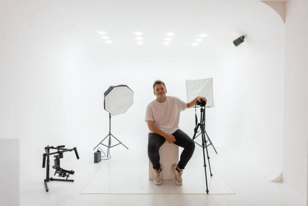 istock Happy male photographer standing in studio 1334540643