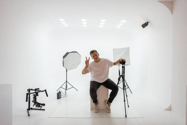 istock Happy male photographer standing in studio 1334540695