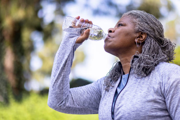istock Senior black woman drinking water during workout 1334541490