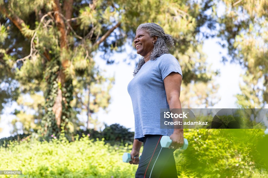 Senior black woman working out fitness outside Senior black woman working out staying healthy outdoors. African-American Ethnicity Stock Photo