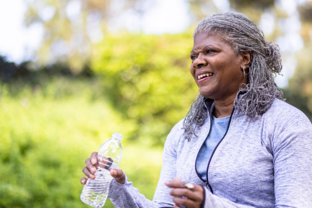 istock Senior black woman drinking water during workout 1334542136
