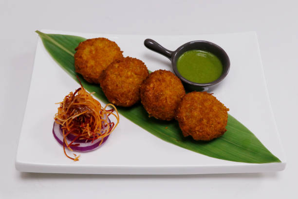 istock corn tikki, also known bhutte ki tikki, deep fried corn patties rolled with corn flakes, indian snack food 1334542199