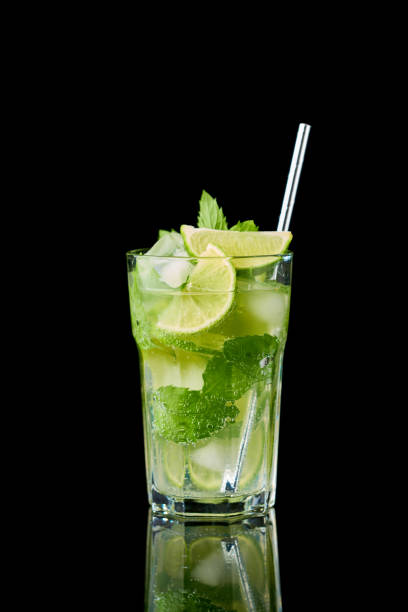 Glass of Fresh Mojito Cocktail - studio shot on black background Glass of Fresh Mojito Cocktail - studio shot on black background. mojito stock pictures, royalty-free photos & images