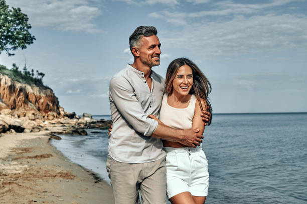 istock Attractive couple cuddling at the beach. 1334547912