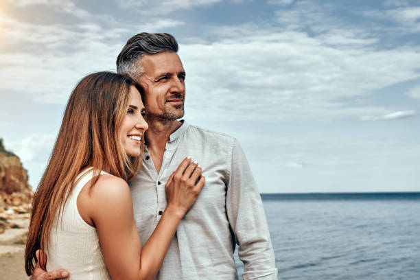 happy couple near sea on sunny summer day. - couple walking old middle imagens e fotografias de stock